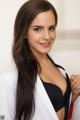 A woman in a white lab coat posing for a picture.