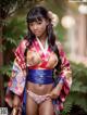 A woman in a kimono posing for a picture.